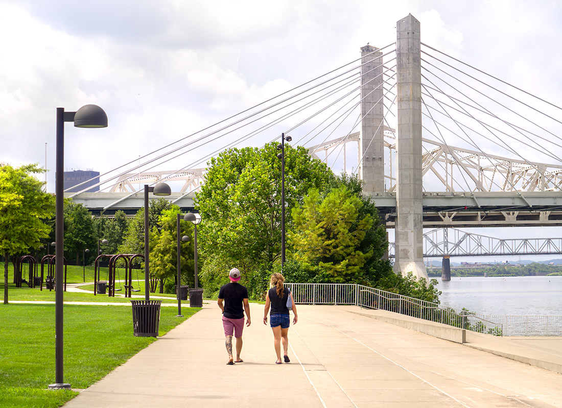Employee Benefits - A Couple Walk on a Path Along Waterfront Park in Louisville Kentucky